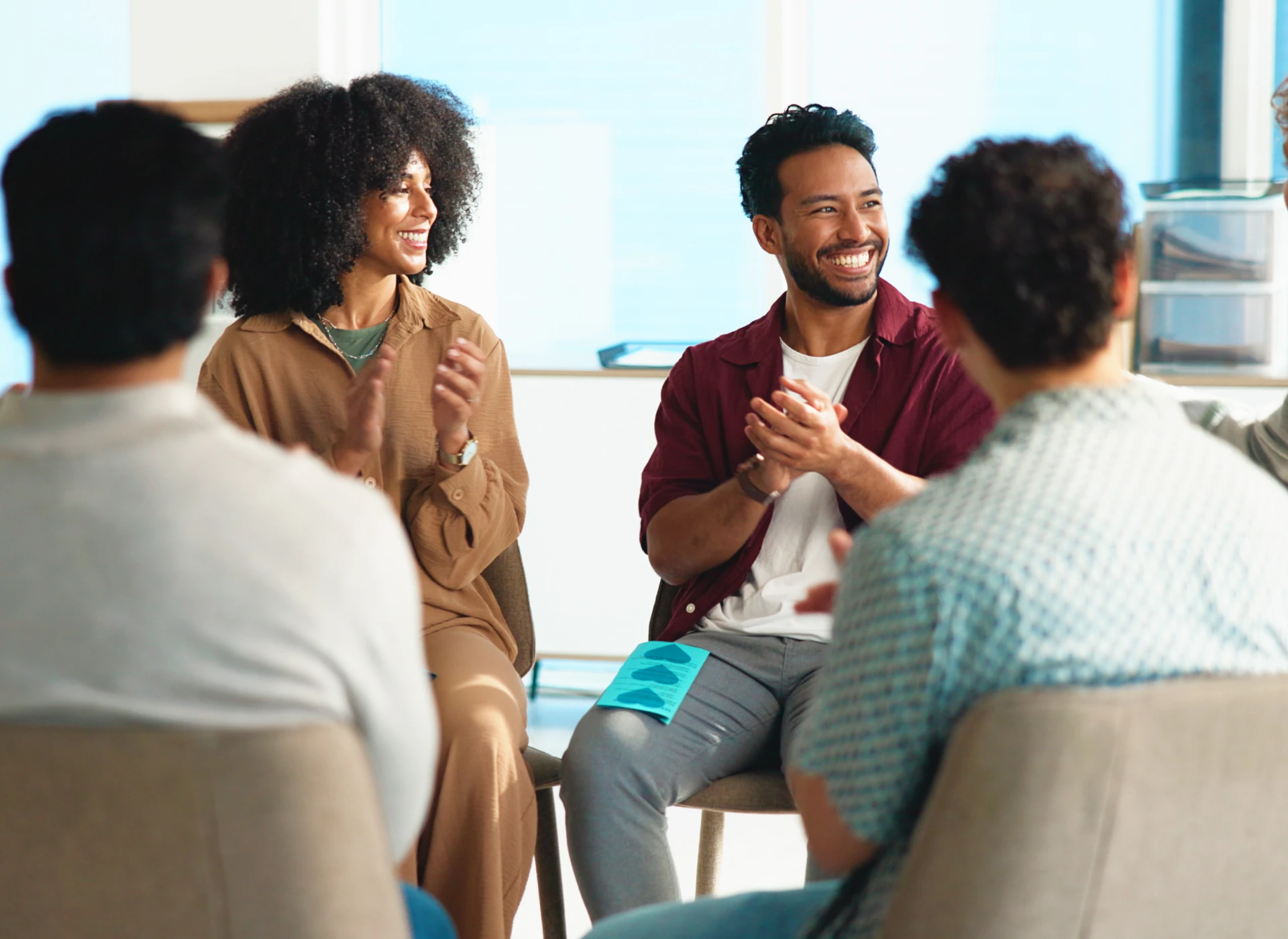 People clapping in a group meeting